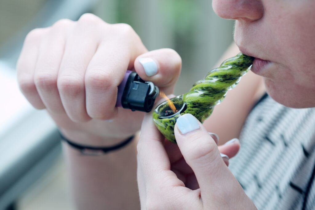 smoking hemp with pipe